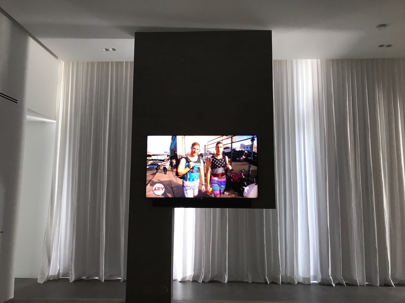 Room with motorized display and drapery integration